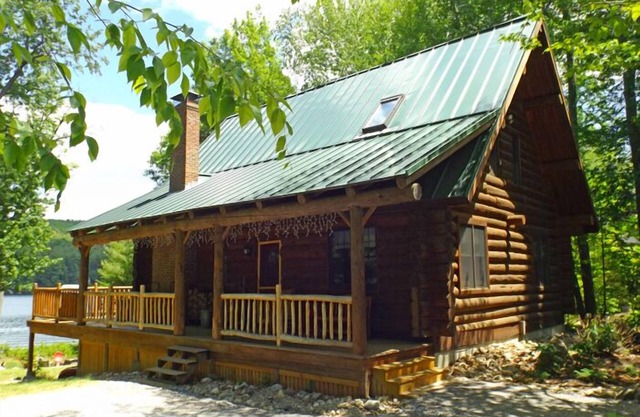 Spacious log cabin with 600' of water frontage on picturesque Moose Pond.