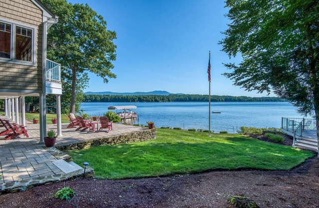 Stunning lakefront property with beach access, a dock, spacious yard, & W/D