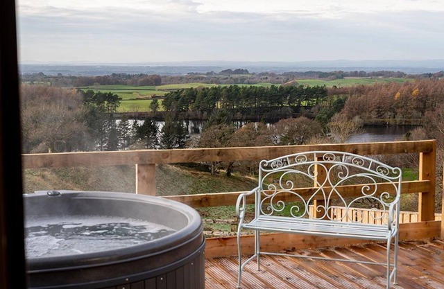 This luxury lodge has its own decking with hot tub
