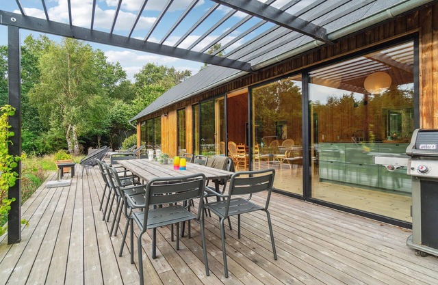 This modern and stylish wooden house welcomes you with round pool in the garden.