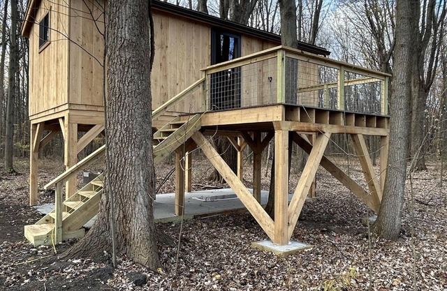 Timber framed tree cabin nestled in the woods.