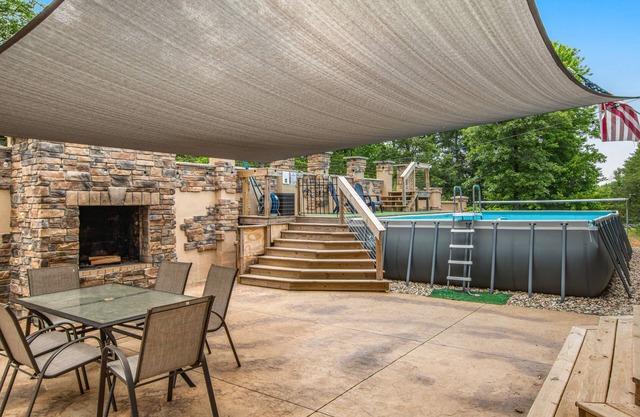 Two-story, dog-friendly home with a pool, indoor/outdoor fireplaces, & AC