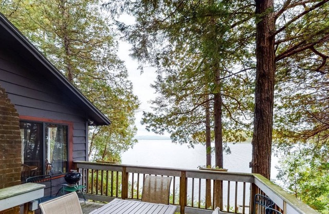 Updated lakefront home in a wooded setting with private dock & beach access