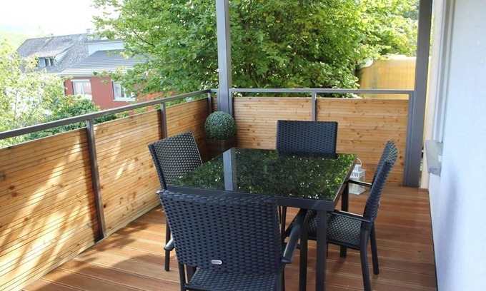 Punderich Apartment | An apartment with a terrace and a roofed balcony, with a view of the Schiefer