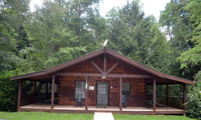 Oneida Cabin | cozy cabin in the woods in a relaxing area with wrap around porch rocking chairs