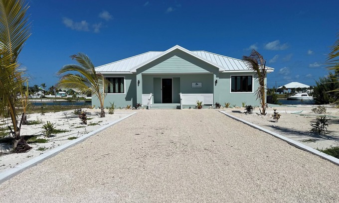Treasure Cay House | Deep water Canal front home w/dock across the street from the beach.
