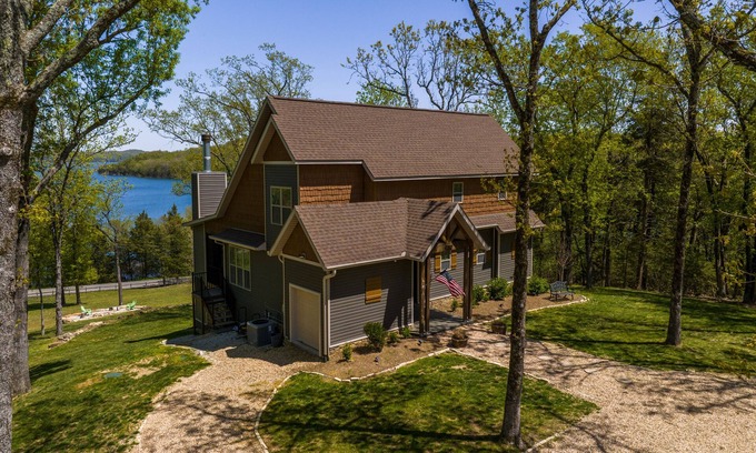 Rogers House | Elegant lakefront home with a fireplace, screened patio & lovely views