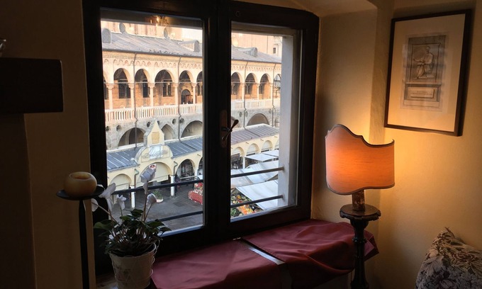Historic Centre Apartment | Elegant two-story apartment with windows overlooking the Palace of Reason.