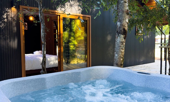 Pucon Cottage | Enarbol Lodge, private hot tube on terrace. High-rise house among trees