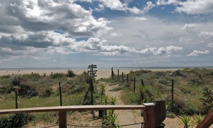 Punta del Moral Apartment | Encantador apartamento con piscina y AC primera línea de playa.