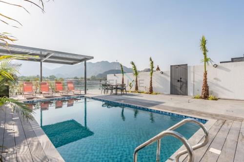 Sharm Apartment | Facing the Sea and Mountains 4BR Villa with Assistant Room and Private Pool, Al Dana Island, Fujairah by Deluxe Holiday Homes
