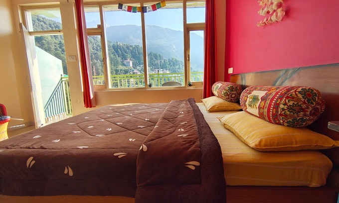 Dharamshala Bed & Breakfast | Golden View BnB Mcleodganj nRoom with private balcony facing mountain view.