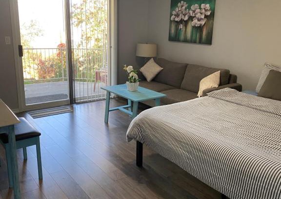Kamloops House | Guest suite with patio that backs onto greenbelt