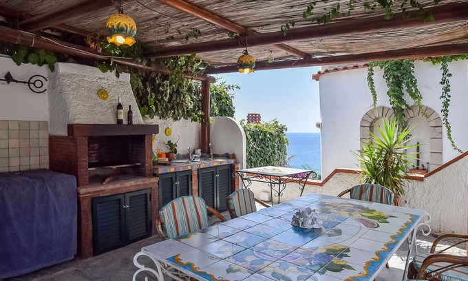 Sant'Angelo House | Inviting cottage with charming outdoor area and limited sea view.