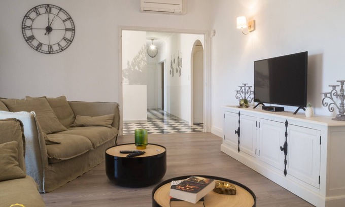 Paradou House | Mas Provençal first floor living room with fireplace and veranda overlooking Alpilles- Vallée des Baux
