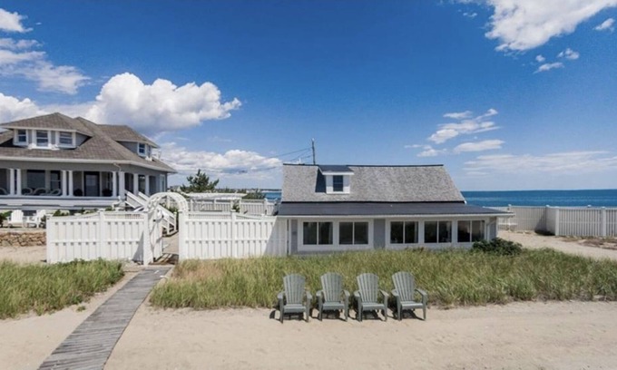 Adamsville Cottage | Oceanfront Cottage with Private Beach and Courtyard. Outside Bar & Fire Table.