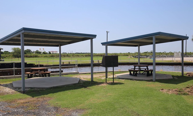 Sabine Pass Cottage | Park your boat in front of the Fishermen's Cottage! Screened in patio.