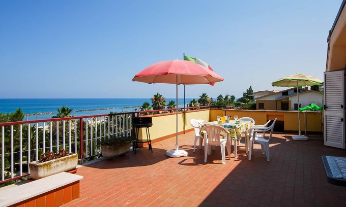 Campofilone Apartment | Relax with a cool drink on your terrace overlooking the sea.