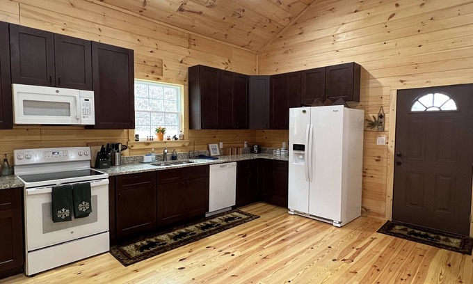 Newland Cabin | Riverfront Luxury Log Cabin with outside fire pit and deck overlooking the water