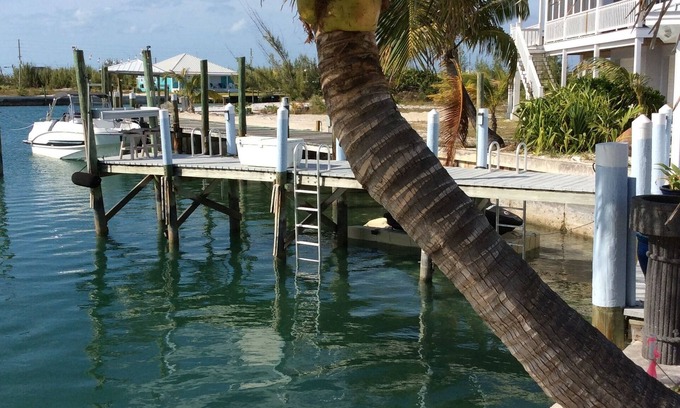 Treasure Cay Villa | Romantic cozy boathouse on the water surrounded by tropical gardens