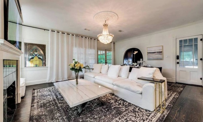 Old East Dallas House | Step into Dallas elegance—historic architecture meets modern luxury minutes from Downtown. Soaring ceilings, crystal chandeliers, and a grand stone fireplace plus contemporary comforts and a huge private balcony.