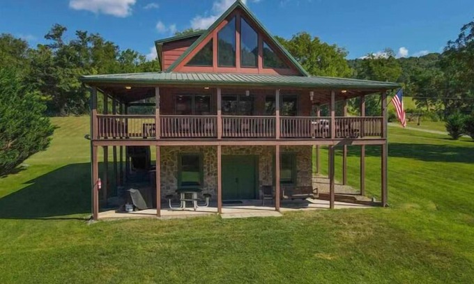 Draper House | Sunny riverside cabin with loft views, big deck, game room, porches, and open lawn.