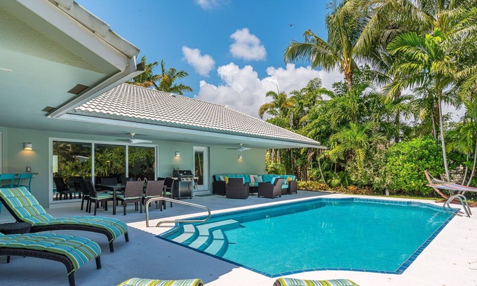 Lake Ida Shores House | The Coconut Canal Hideout- Waterfront, Heated Pool, Minutes to Downtown Delray!