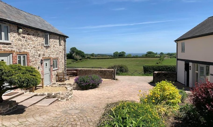 Oswestry House | The Granary at Pentregaer Ucha, tennis court & lake.