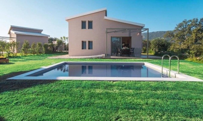 Doukades Villa | The villa's large private garden leads directly to the outdoor private pool.