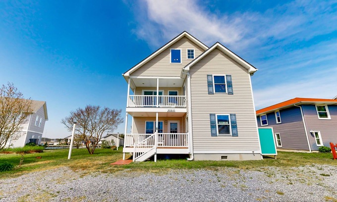 Cedar Neck House | Town of Ocean View canal-front home with dock, kayaks, balconies, grill, & AC