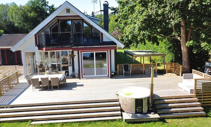 Vissefjaerda House | Vacation home right on the lake in Småland - Villa lake view with hot tub, boat & canoe
