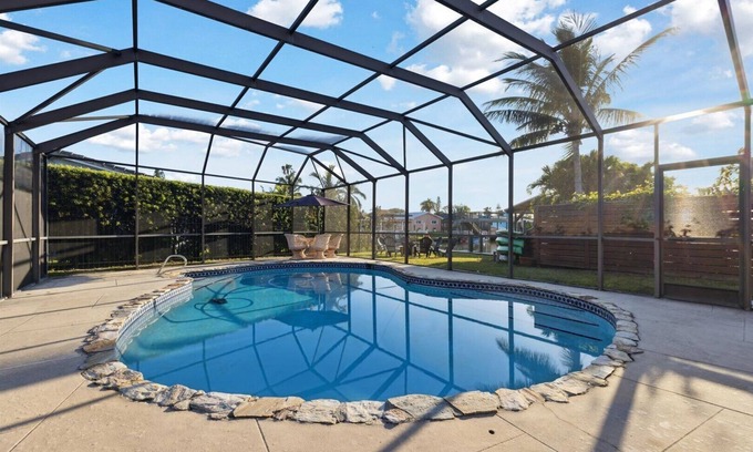 Venetian Way House | Your Ultimate Coastal Retreat! Stunning 4-Bed Canal-Front Home w/Pool & Lanai