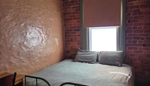 Queen bed with shared amenity
