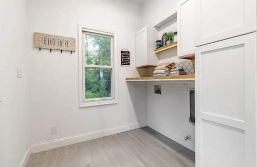 Mickleton House | Embrace the charm of our creekside haven featuring 4BR 3BA yoga and BBQ deck.