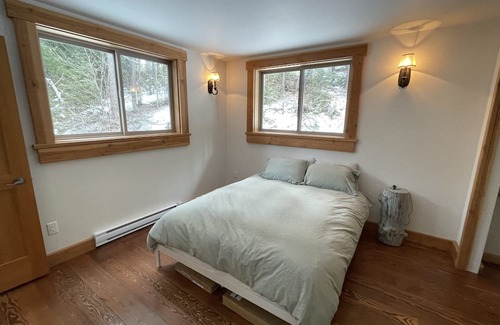 Squamish-Lillooet Regional District Cabin | Cozy mountain cabin retreat steps to trails and beautiful Gun Lake.