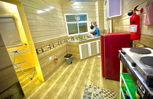 Seeb Apartment | Bedroom with an attached bathroom, shared kitchen in area with everything around