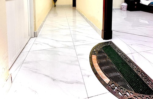 Seeb Apartment | Bedroom with an attached bathroom, shared kitchen in area with everything around