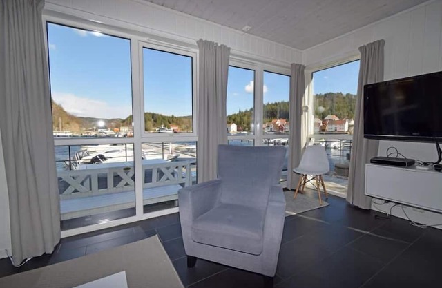 Holiday home 'Furuholmen Brygge 7', Furuholmen peninsula near Lindesnes, southern Norway, up to 7 people possible, e.g. 4 adults and 3-4 kids, 4 bedrooms, 2 shower-bathrooms, modern equipment, terrace and boat mooring in front of the house on the .
