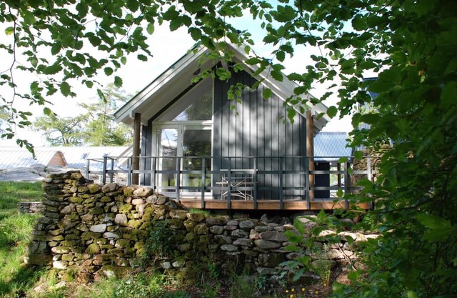 Luxury waterfall cottage with private hot tub at Loch Tay