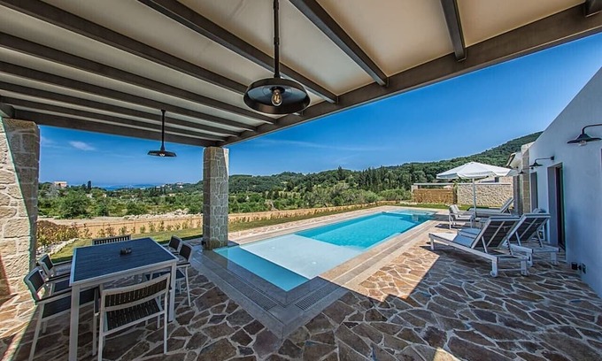 Kavvadades Villa | Alluring Corfu Villa | Villa Corallia | 2 Bedrooms | Spacious Furnished Terrace with Shaded Outdoor Dining Area | Private Garden, Pool and Hot Tub | Prime Location | Arillas, Mega Lithari
